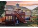 Back of a home with a two-level deck in the backyard at sunset at 3709 Mcguire Nw St, Kennesaw, GA 30144