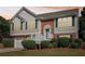 Charming two-story home with a brick and siding exterior, manicured landscaping, and a welcoming front porch at 3709 Mcguire Nw St, Kennesaw, GA 30144