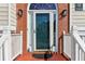 Close up of front door with decorative window and stylish wall-mounted sconces at 3709 Mcguire Nw St, Kennesaw, GA 30144
