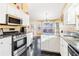 Modern kitchen featuring stainless steel appliances, granite countertops, and white cabinetry at 3709 Mcguire Nw St, Kennesaw, GA 30144