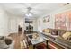 Living room featuring hardwood floors, neutral walls, a ceiling fan, and a plush sofa with throw pillows at 3709 Mcguire Nw St, Kennesaw, GA 30144