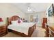 Comfortable bedroom with a large wooden bed, dresser, and ceiling fan at 3709 Mcguire Nw St, Kennesaw, GA 30144