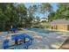 Neighborhood pool featuring tables, pool house, and gazebo surrounded by mature trees at 3709 Mcguire Nw St, Kennesaw, GA 30144