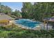 Gated community pool featuring picnic tables, gazebo and pool house set among mature trees at 3709 Mcguire Nw St, Kennesaw, GA 30144