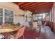 Relaxing sunroom featuring a painted wood floor and ceiling, neutral furniture, and ample natural light at 3709 Mcguire Nw St, Kennesaw, GA 30144