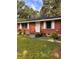 A single-story red brick home with white trim and a well-kept front lawn at 4513 College St, Forest Park, GA 30297