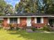 Charming single-story red brick home with a well-maintained front yard and white shutters at 4513 College St, Forest Park, GA 30297