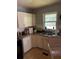A functional kitchen with white cabinets, double sink, and window for natural light at 4513 College St, Forest Park, GA 30297