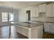 Open kitchen featuring a large island with granite countertop, modern cabinetry, and stainless sink at 6149 Pinewood Se Dr, Covington, GA 30014