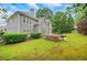 Large backyard with a patio area, outdoor kitchen and lush landscaping, perfect for relaxation and entertaining at 1473 Cardova Pointe, Dunwoody, GA 30338