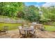 Stone patio featuring a stainless steel barbeque, dining table, and beautiful greenery at 1473 Cardova Pointe, Dunwoody, GA 30338