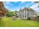 Well-maintained backyard featuring a spacious lawn, stone patio, and outdoor seating area, perfect for entertaining at 1473 Cardova Pointe, Dunwoody, GA 30338