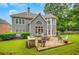 Beautiful backyard with stone patio, outdoor kitchen, and lush lawn ideal for gatherings and relaxation at 1473 Cardova Pointe, Dunwoody, GA 30338