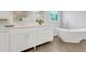Elegant bathroom features double vanity, soaking tub, and tile floors at 1473 Cardova Pointe, Dunwoody, GA 30338