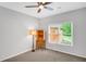 A clean bedroom with carpet, white walls, and a window that lets in natural light at 1473 Cardova Pointe, Dunwoody, GA 30338