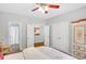 Bright bedroom features ceiling fan, double doors, and painted armoire at 1473 Cardova Pointe, Dunwoody, GA 30338