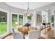 Bright breakfast nook with hardwood floors, a round table, and windows overlooking the backyard at 1473 Cardova Pointe, Dunwoody, GA 30338