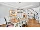 Dining room with classic decor, including hardwood floors, chandelier, and sideboard with decorative lamps at 1473 Cardova Pointe, Dunwoody, GA 30338