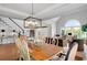 Dining area with hardwood floors, stylish chairs, and a view of the staircase and living spaces at 1473 Cardova Pointe, Dunwoody, GA 30338