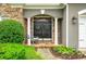 Inviting home entrance featuring stone accents, a rocking chair, and double front doors at 1473 Cardova Pointe, Dunwoody, GA 30338
