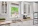 This kitchen features granite counters, modern appliances, and bright lighting at 1473 Cardova Pointe, Dunwoody, GA 30338