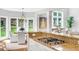 This open kitchen features granite countertops, an island gas cooktop, and backyard views at 1473 Cardova Pointe, Dunwoody, GA 30338
