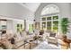 Spacious living room featuring hardwood floors, stylish seating, and a large arched window at 1473 Cardova Pointe, Dunwoody, GA 30338