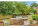 Stone outdoor kitchen with grill, patio seating, and lush greenery perfect for alfresco dining and entertaining at 1473 Cardova Pointe, Dunwoody, GA 30338