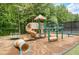 Community playground featuring slide, tunnel, and various play structures nestled among mature trees at 1473 Cardova Pointe, Dunwoody, GA 30338