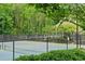 Serene community tennis court, surrounded by lush greenery, providing a secluded spot for sports and recreation at 1473 Cardova Pointe, Dunwoody, GA 30338