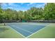 Community tennis courts are surrounded by mature trees, providing a private, sporty atmosphere at 1473 Cardova Pointe, Dunwoody, GA 30338