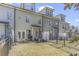 Exterior view of the townhome backyard featuring a well-maintained lawn, patio area, and privacy fencing at 2772 Archway Ln, Brookhaven, GA 30341