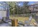 View of the private fenced-in backyard, landscaped with lush lawn and patio seating area, perfect for outdoor relaxation at 2772 Archway Ln, Brookhaven, GA 30341