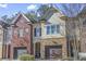 Charming townhome with a one car garage, brick and siding exterior with a covered front porch at 2772 Archway Ln, Brookhaven, GA 30341
