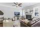 Comfortable living room with a fireplace, a ceiling fan and a large sofa creating a relaxing space at 2772 Archway Ln, Brookhaven, GA 30341