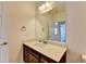 Bathroom featuring a large mirror, vanity with dark wood cabinets, and brushed gold fixtures at 3411 Lindenridge Dr, Buford, GA 30519