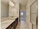 Bright bathroom featuring double sink vanity, tile flooring, and walk-in shower at 3411 Lindenridge Dr, Buford, GA 30519