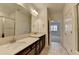 Bright bathroom featuring double sink vanity, tile flooring, and walk-in shower at 3411 Lindenridge Dr, Buford, GA 30519