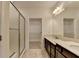 Bathroom showcasing a glass enclosed shower, large vanity and walk-in closet at 3411 Lindenridge Dr, Buford, GA 30519