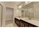 Bathroom featuring a vanity with double sinks, large mirror and walk-in closet at 3411 Lindenridge Dr, Buford, GA 30519