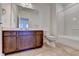 Bathroom showcasing tile flooring, vanity, toilet, shower with white walls and brushed gold hardware at 3411 Lindenridge Dr, Buford, GA 30519