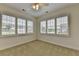 Bright bedroom featuring neutral carpet, ample natural light from large windows and a ceiling fan at 3411 Lindenridge Dr, Buford, GA 30519