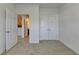 Bright bedroom with neutral carpet, walk-in closet and doorway to kitchen or dining area at 3411 Lindenridge Dr, Buford, GA 30519