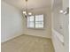 Dining room with a decorative chandelier, white trim, and a bright window with shuttered blinds at 3411 Lindenridge Dr, Buford, GA 30519