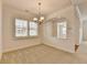 Dining room featuring a decorative chandelier, white trim, and an open view to the entry at 3411 Lindenridge Dr, Buford, GA 30519