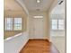 Bright foyer with hardwood floors, white trim, and views to other rooms through shuttered windows at 3411 Lindenridge Dr, Buford, GA 30519