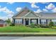 Charming brick townhome featuring a lush green lawn, tidy landscaping, and inviting curb appeal at 3411 Lindenridge Dr, Buford, GA 30519