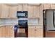 Well-equipped kitchen with stainless steel appliances, light wood cabinets, and sleek countertops at 3411 Lindenridge Dr, Buford, GA 30519