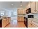 Bright, open kitchen with stainless appliances and seamless flow into the living area for easy entertaining at 3411 Lindenridge Dr, Buford, GA 30519