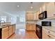 Open kitchen flowing into the living area, complete with stainless steel appliances and modern finishes at 3411 Lindenridge Dr, Buford, GA 30519